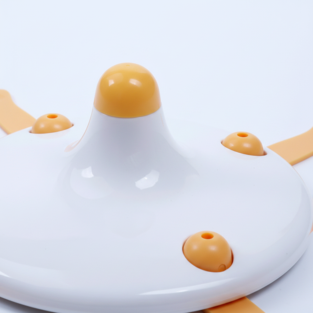 Close-up detail of electric cat toy center yellow spinning ball and orange arm joint