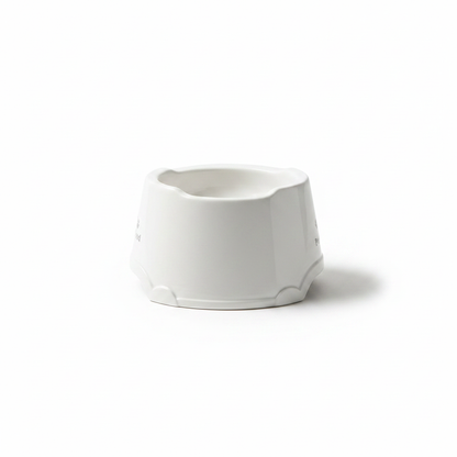White ceramic pet food bowl with paw print — side profile view