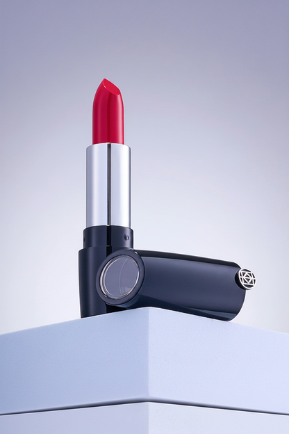 Luxury navy blue lipstick with red bullet on white pedestal studio shot